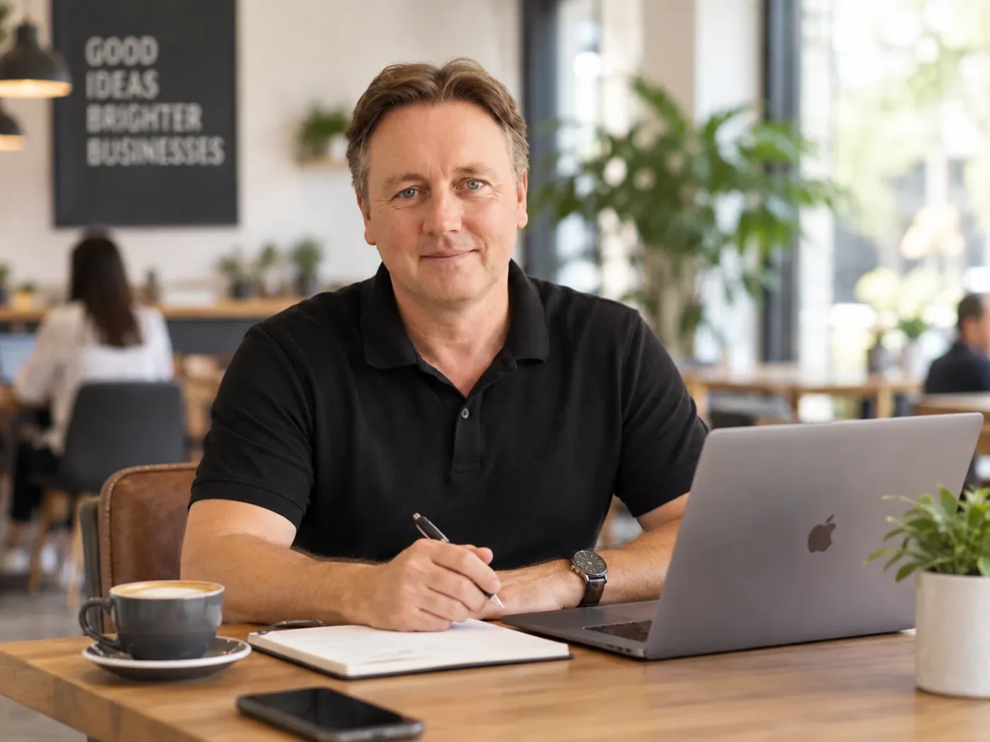 Keith Fletcher, founder of Ocean Website Design, working at a laptop in a Perth café
